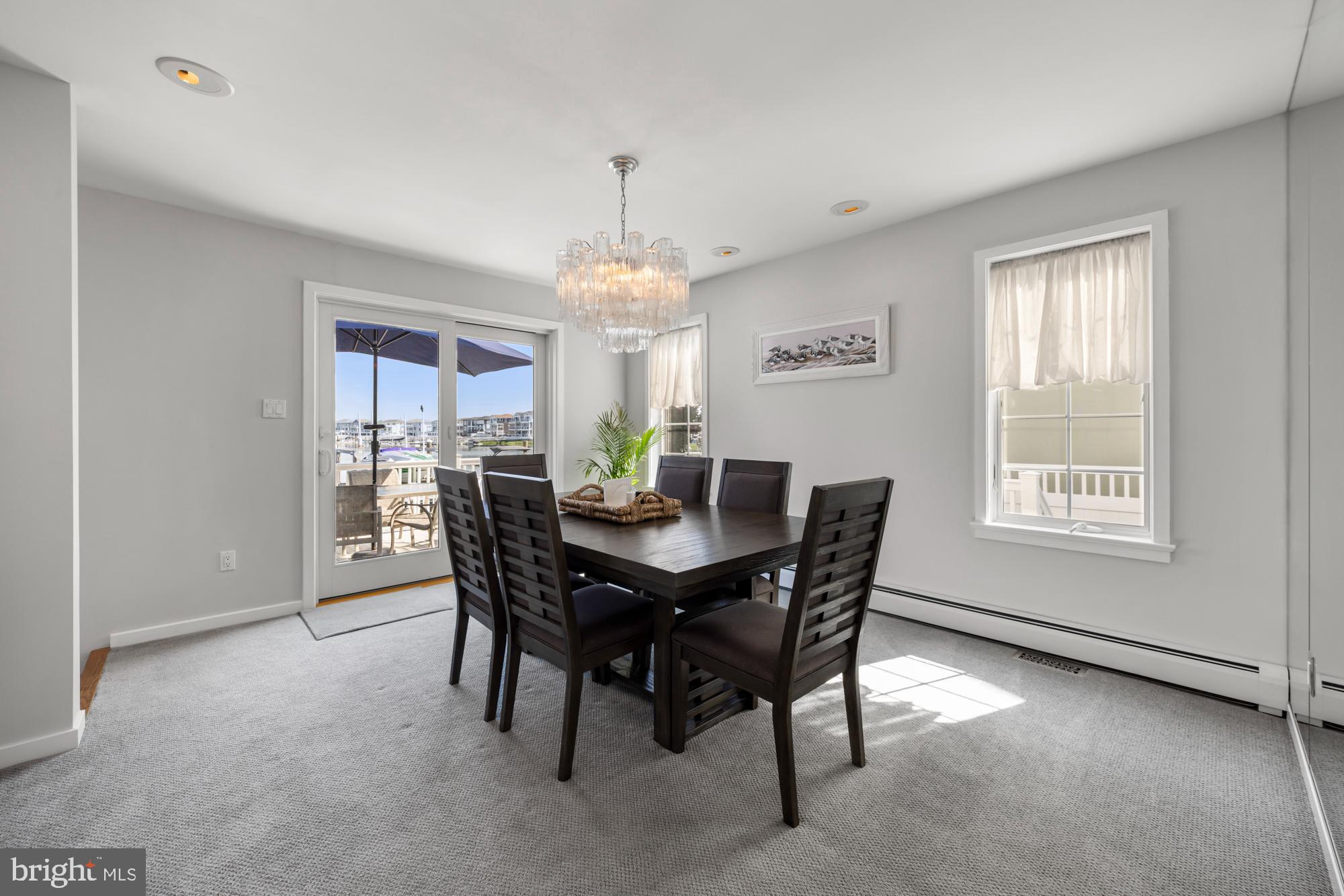 87 Lagoon Boulevard Brigantine, NJ 08203 - Photo 15 of 66 a view of a dining room with furniture and window
