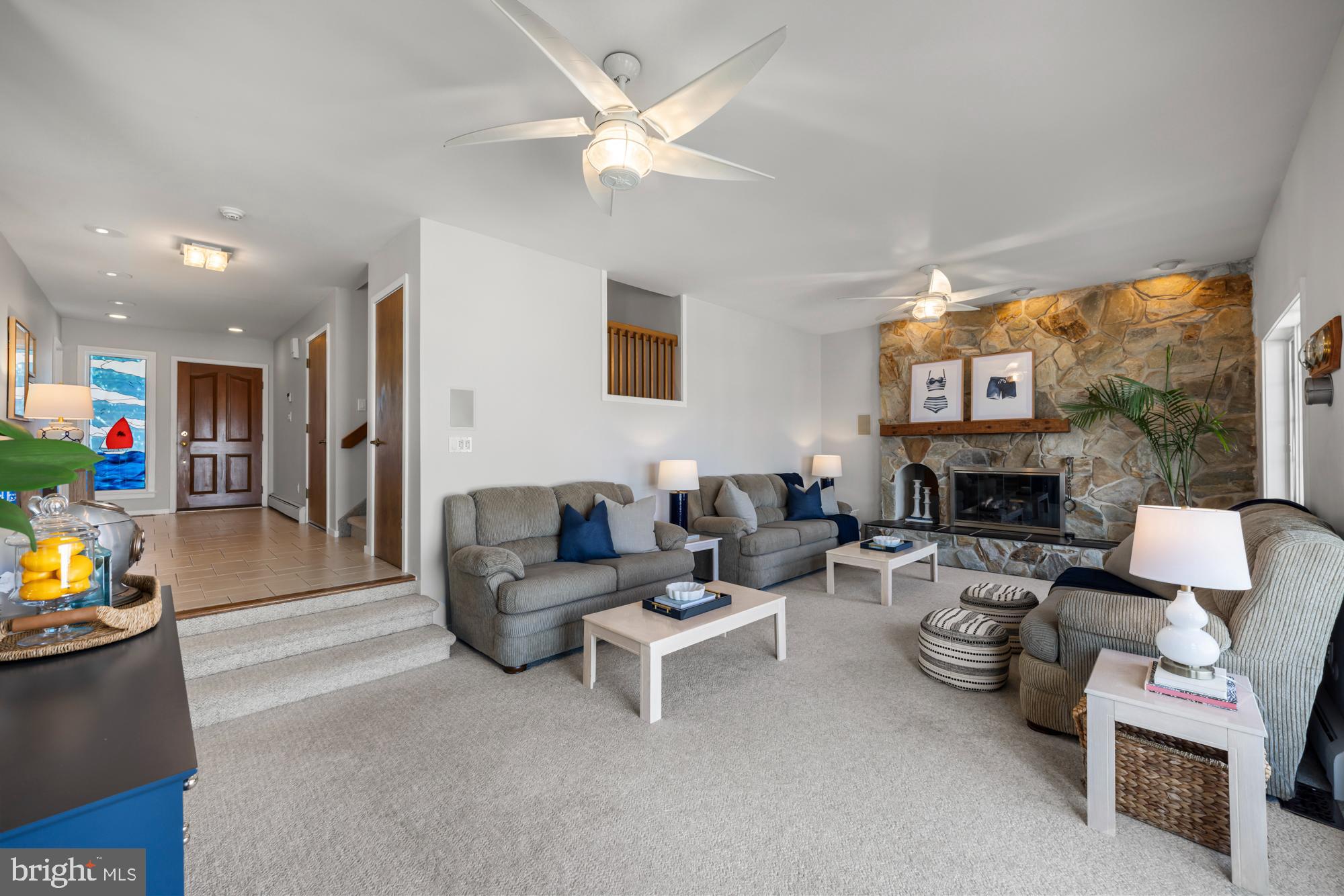 87 Lagoon Boulevard Brigantine, NJ 08203 - Photo 16 of 66 a living room with furniture and a fireplace