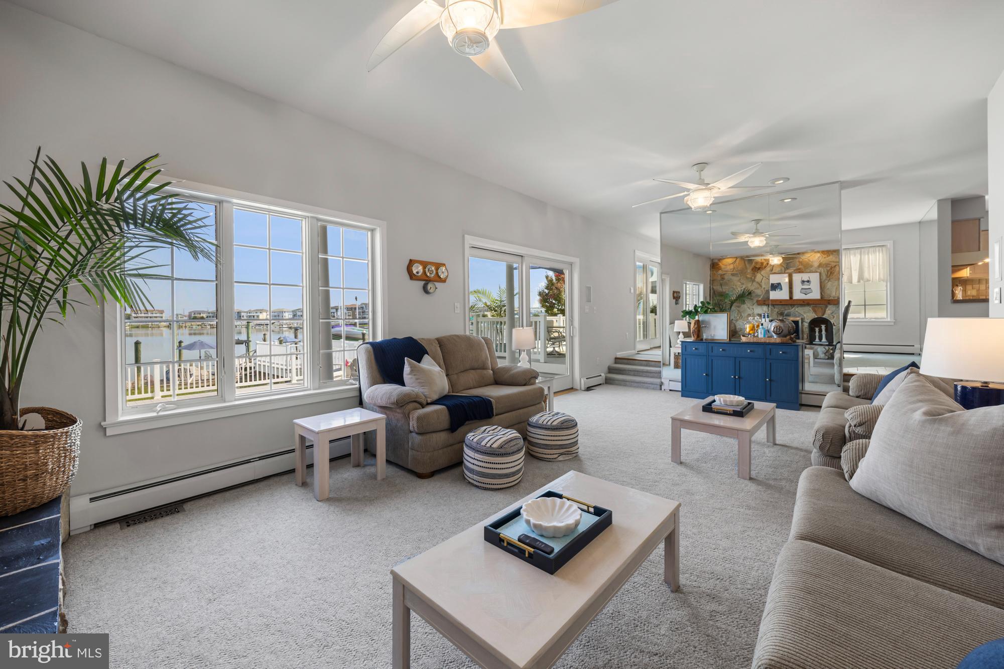 87 Lagoon Boulevard Brigantine, NJ 08203 - Photo 18 of 66 a living room with furniture and a large window