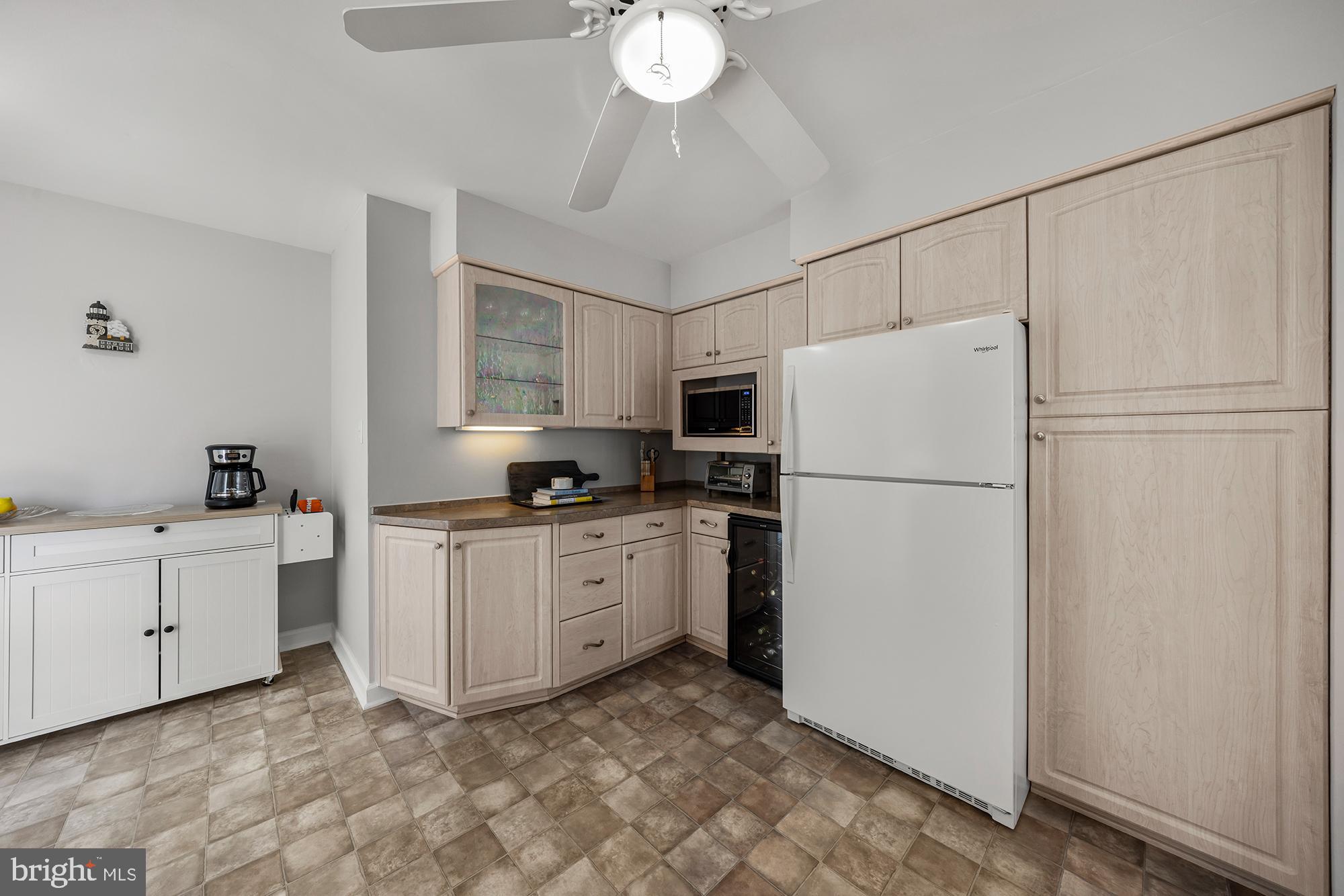 87 Lagoon Boulevard Brigantine, NJ 08203 - Photo 22 of 66 a kitchen with cabinets a refrigerator and a stove top oven