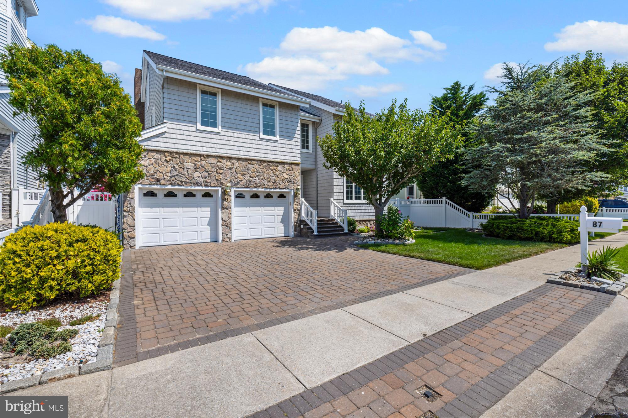 87 Lagoon Boulevard Brigantine, NJ 08203 - Photo 3 of 66 a front view of a house with a yard and a garage