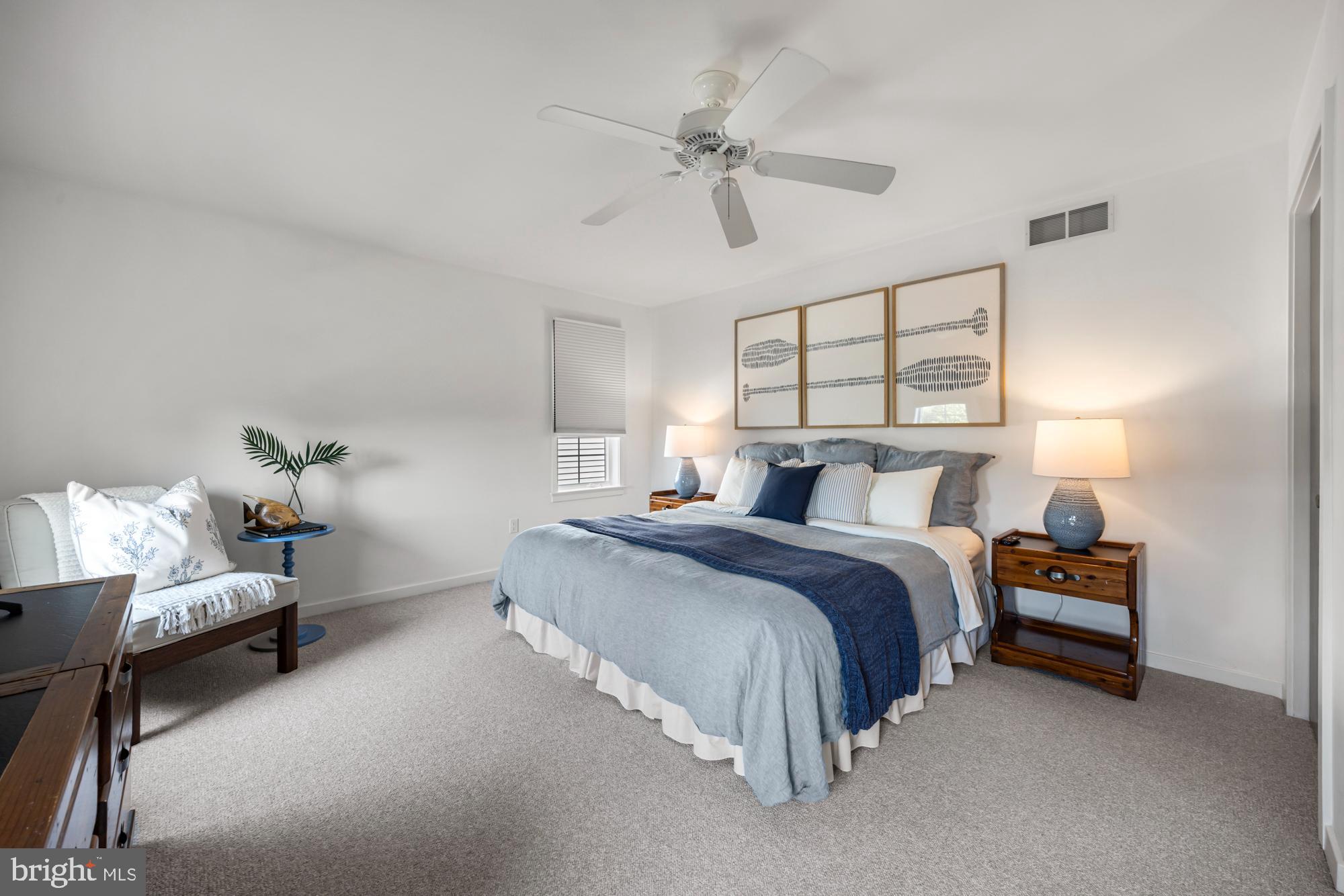 87 Lagoon Boulevard Brigantine, NJ 08203 - Photo 32 of 66 a spacious bedroom with a bed and a window