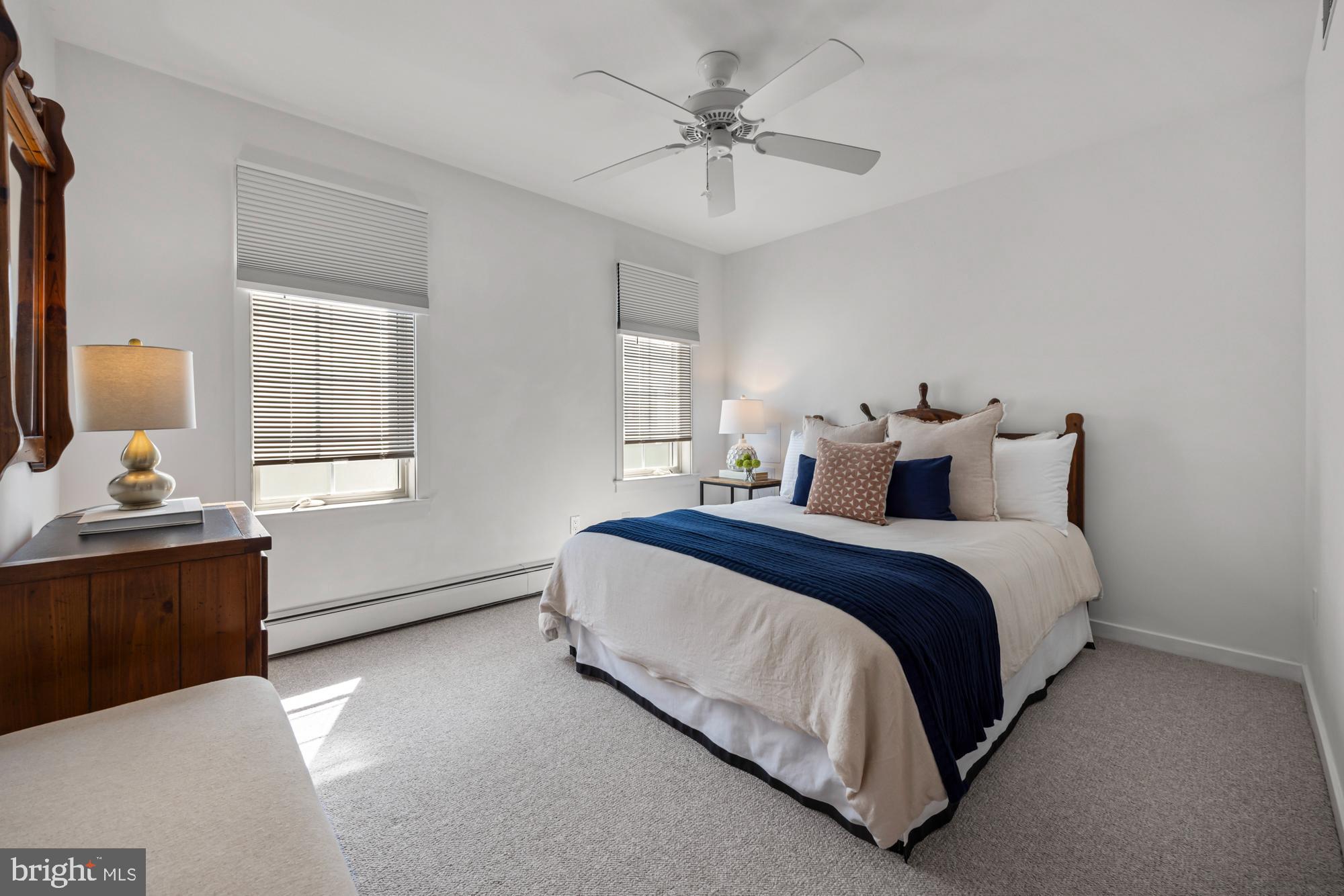 87 Lagoon Boulevard Brigantine, NJ 08203 - Photo 33 of 66 a spacious bedroom with a bed and a chandelier