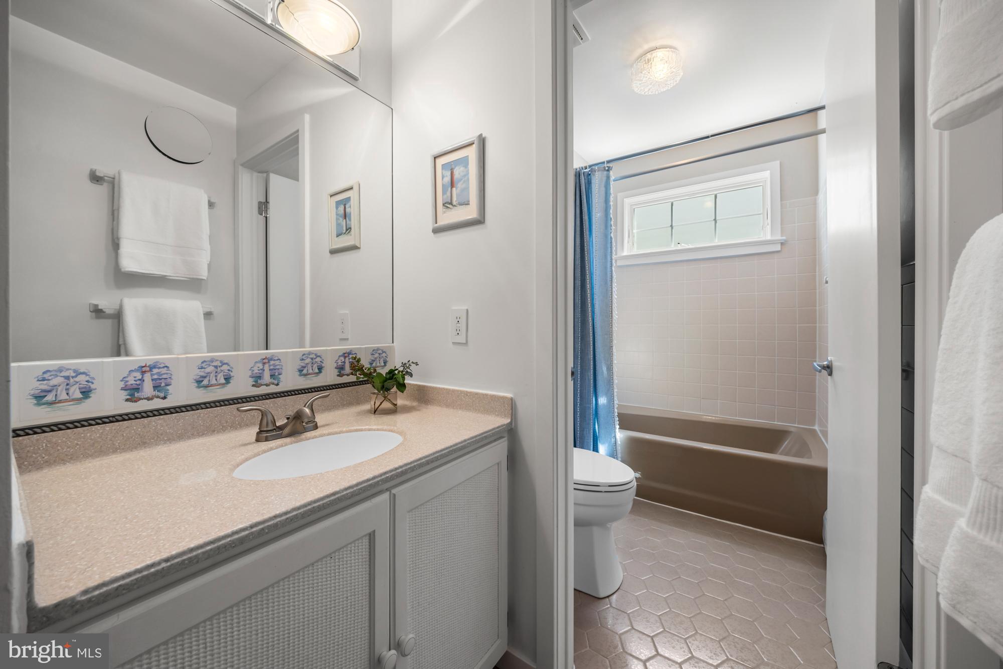 87 Lagoon Boulevard Brigantine, NJ 08203 - Photo 36 of 66 a bathroom with a sink a toilet and shower