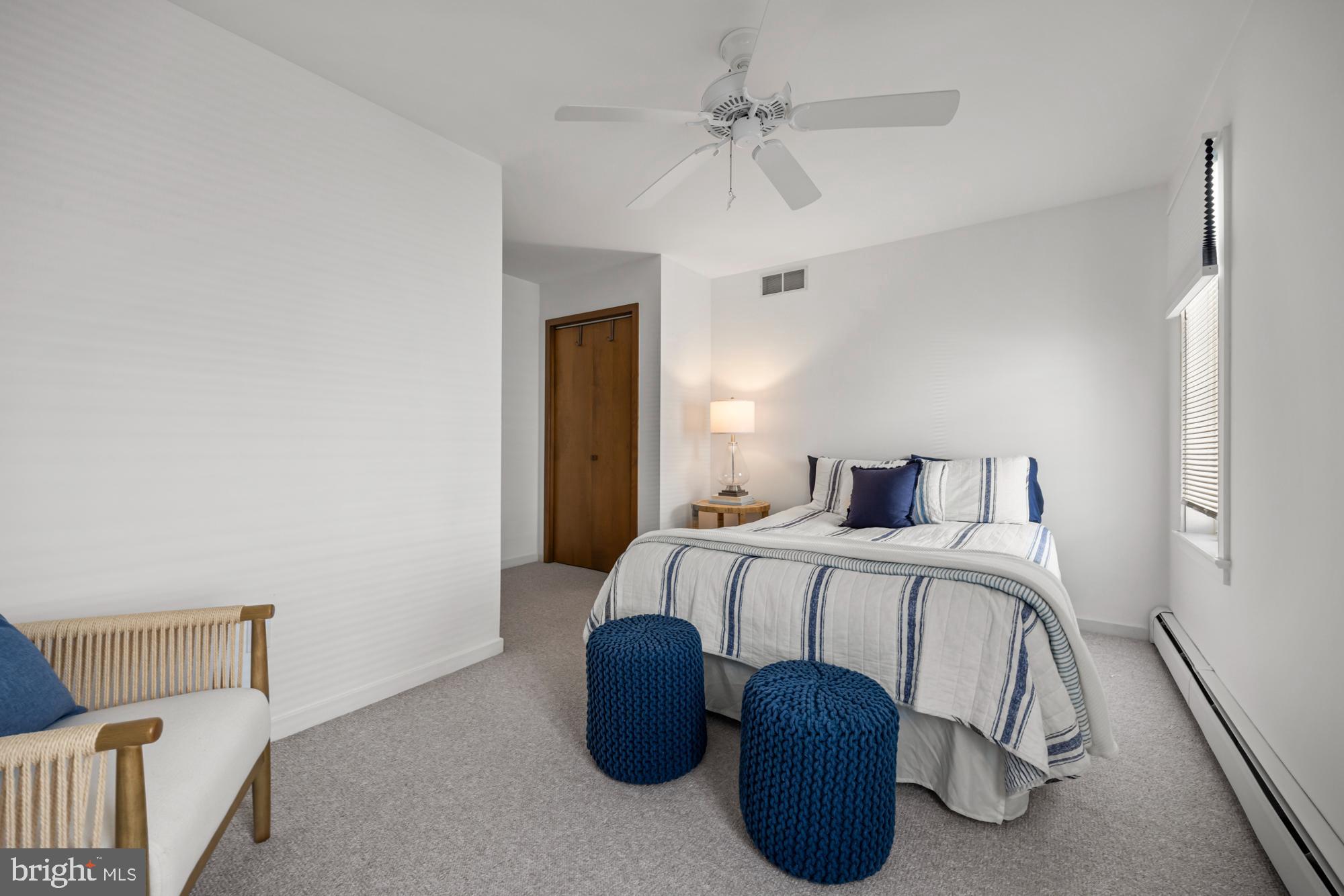 87 Lagoon Boulevard Brigantine, NJ 08203 - Photo 37 of 66 a bedroom with a bed and a chandelier