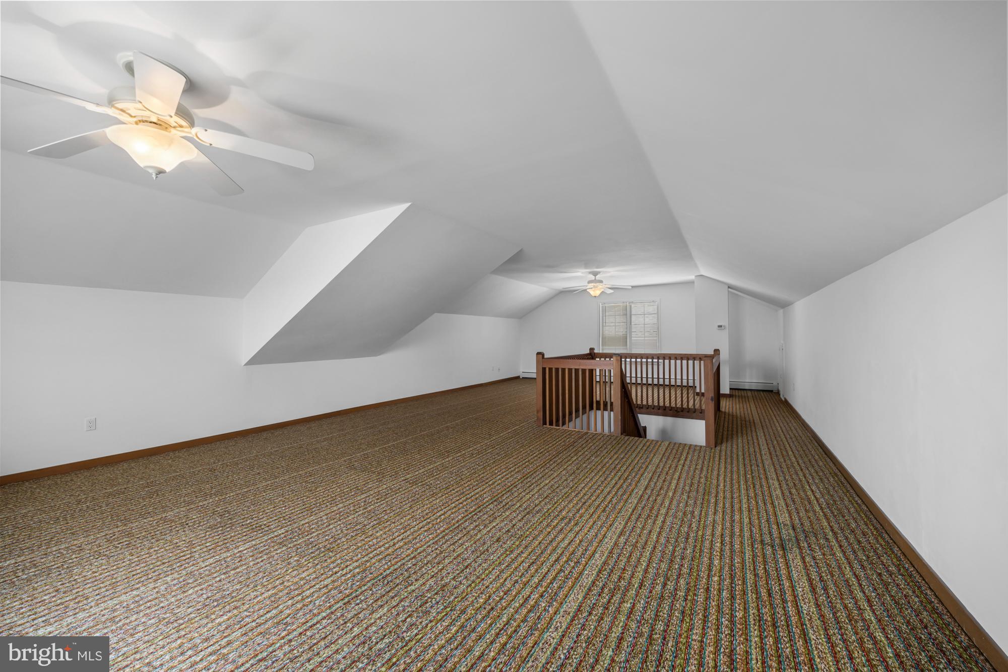 87 Lagoon Boulevard Brigantine, NJ 08203 - Photo 40 of 66 a view of an empty room with chandelier fan and wooden floor