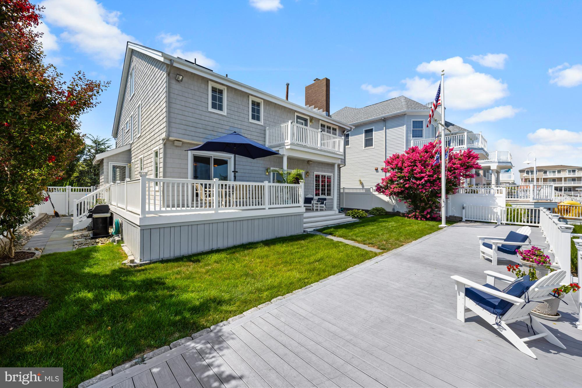 87 Lagoon Boulevard Brigantine, NJ 08203 - Photo 50 of 66 a front view of house with a garden