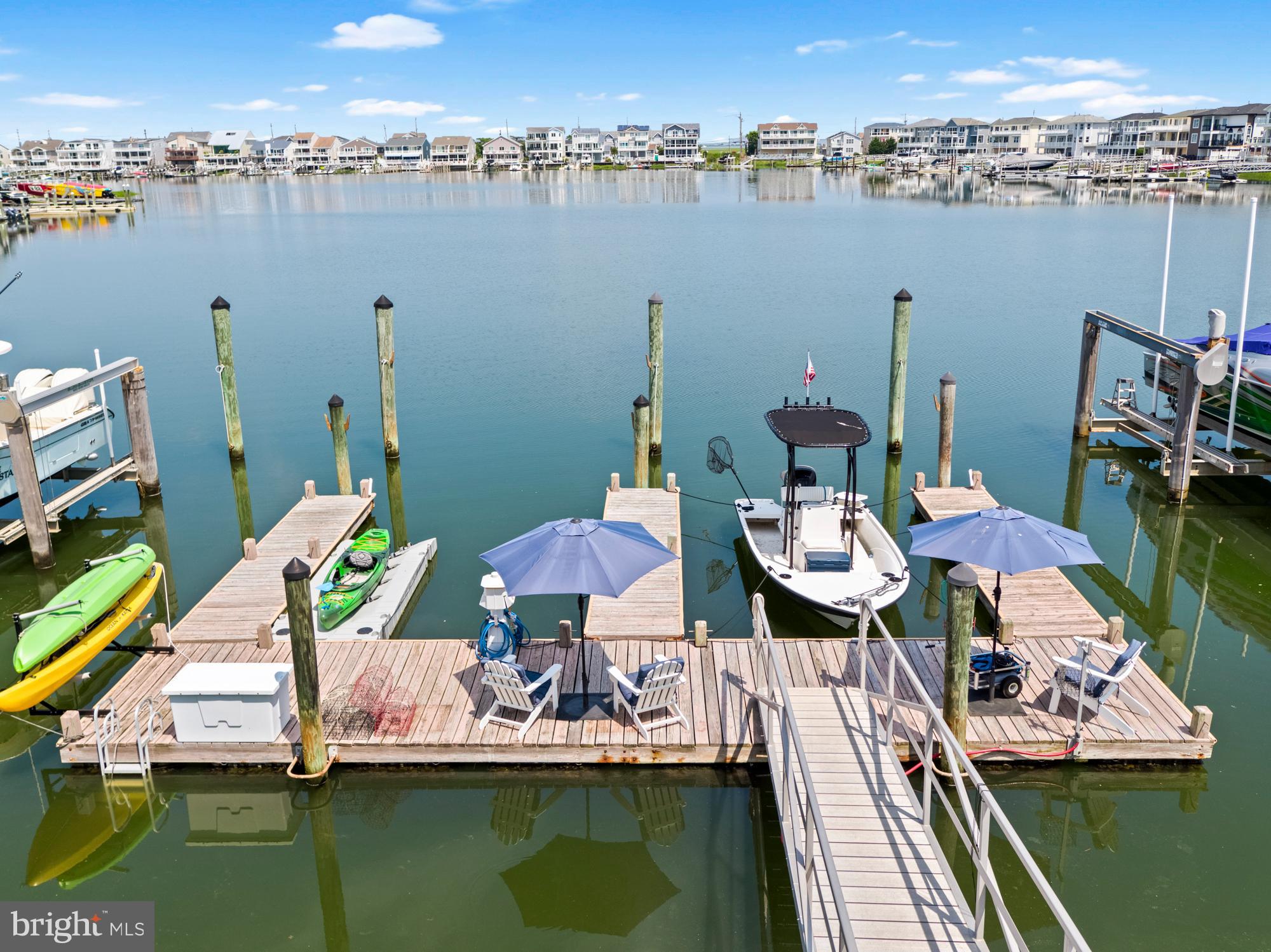 87 Lagoon Boulevard Brigantine, NJ 08203 - Photo 56 of 66 a view of a lake with a table and chairs
