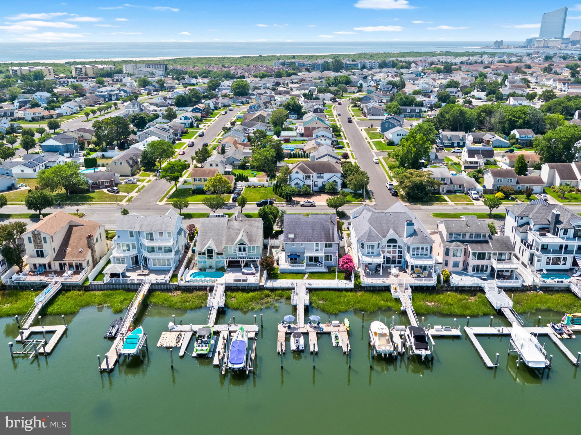 87 Lagoon Boulevard Brigantine, NJ 08203 - Photo 59 of 66 an aerial view of a play ground and front of residential houses with outdoor space