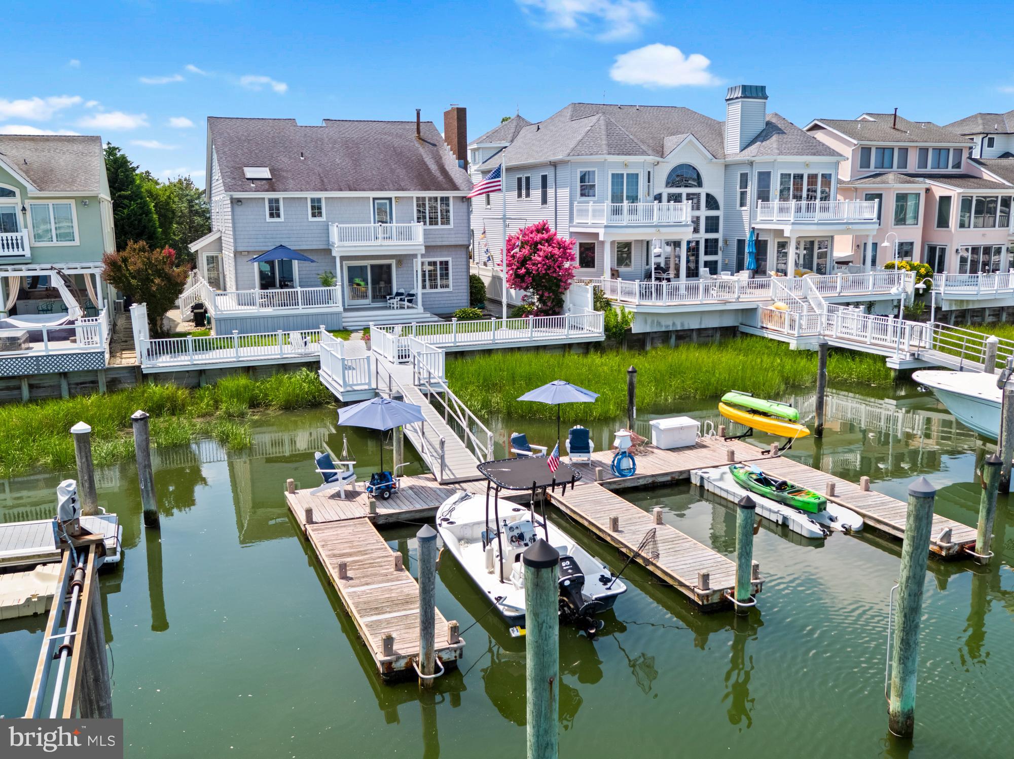 87 Lagoon Boulevard Brigantine, NJ 08203 - Photo 61 of 66 a view of a lake with a house swimming pool and outdoor seating
