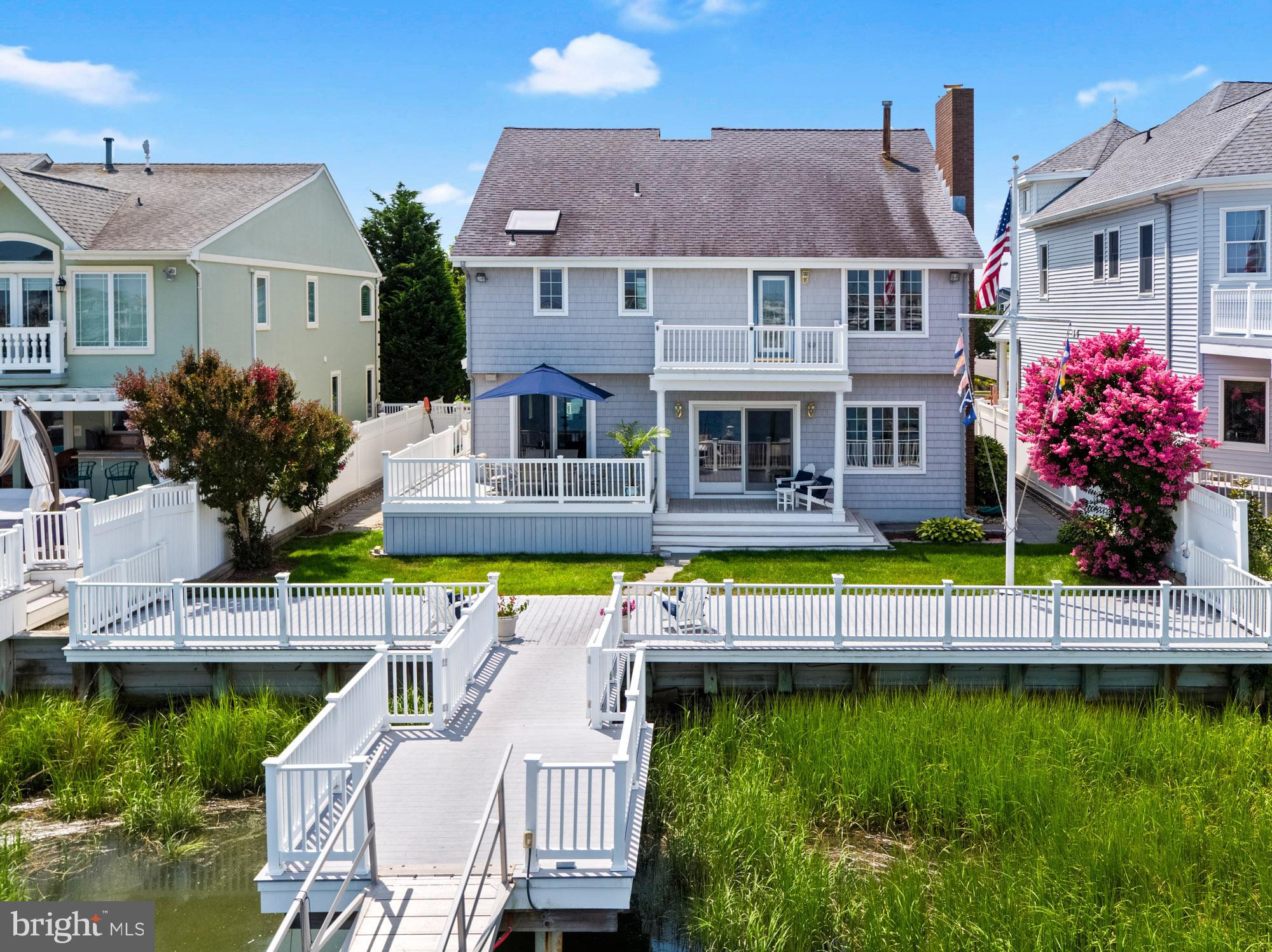 87 Lagoon Boulevard Brigantine, NJ 08203 - Photo 63 of 66 a view of house with a swimming pool and outdoor seating