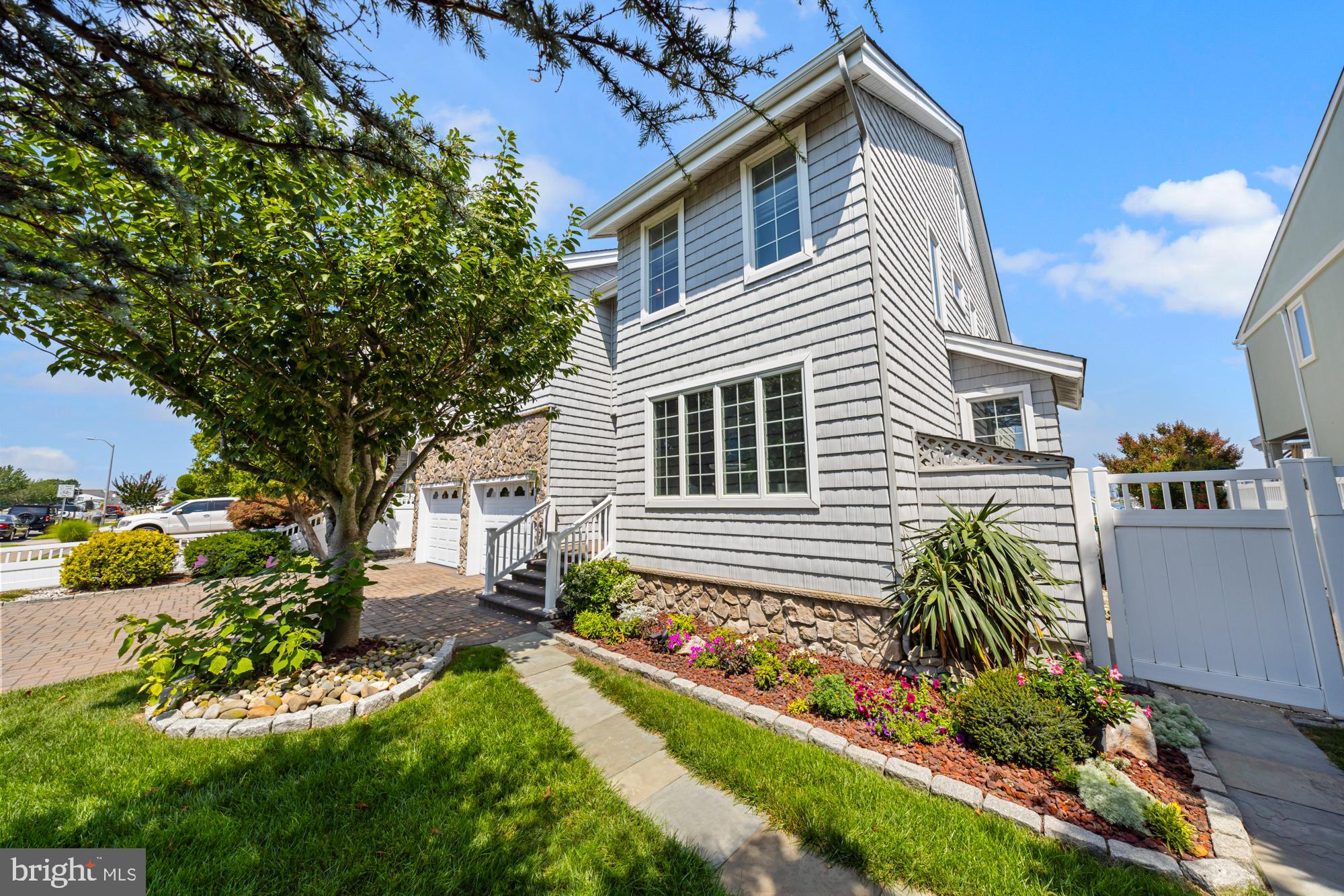 87 Lagoon Boulevard Brigantine, NJ 08203 - Photo 8 of 66 a front view of a house with a yard