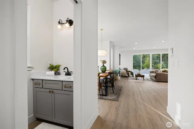 a view of a livingroom with furniture hardwood floor and a ceiling fan