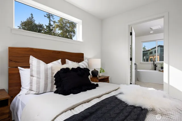 a bedroom with a bed mirror and wall painting