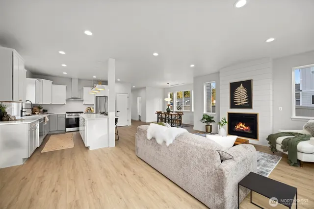 a living room with fireplace furniture and a wooden floor