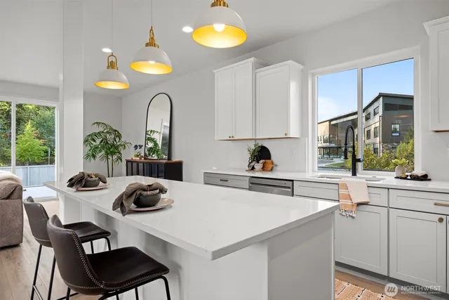 a kitchen with a table chairs a stove and a window