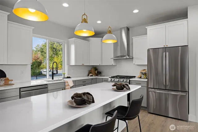 a kitchen with a sink a refrigerator a stove and a cabinets