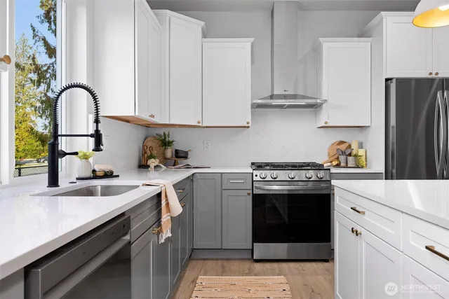a kitchen with stainless steel appliances granite countertop a sink stove and refrigerator