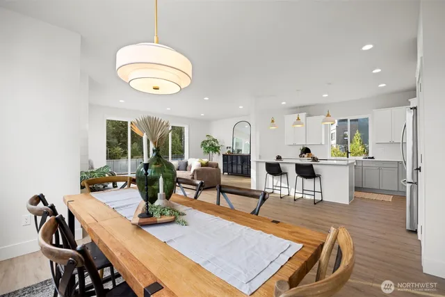a living room with dining room and kitchen view