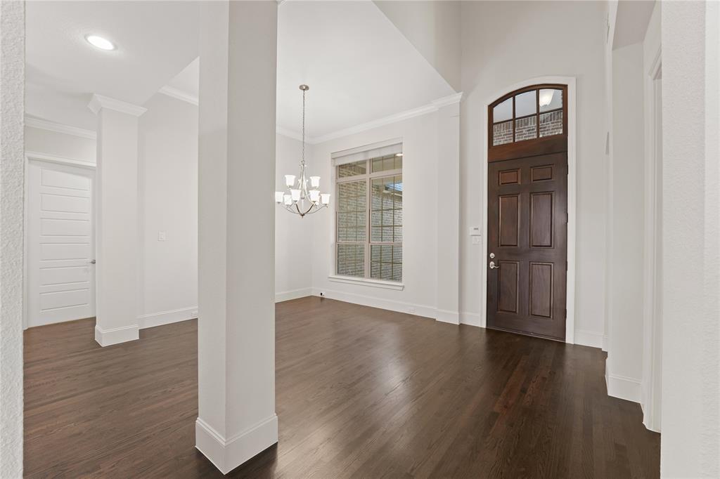 4026 North Cresthaven Road Dallas, TX 75209 - Photo 13 of 22 a view of an empty room with wooden floor and a window