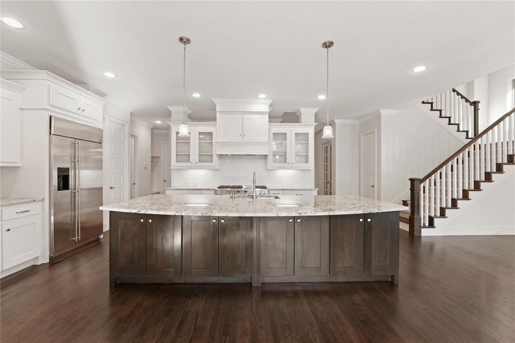 4026 North Cresthaven Road Dallas, TX 75209 - Photo 4 of 22 a large kitchen with stainless steel appliances kitchen island granite countertop a large island in the center