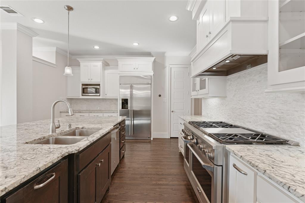 4026 North Cresthaven Road Dallas, TX 75209 - Photo 5 of 22 a kitchen with stainless steel appliances granite countertop a sink stove and refrigerator