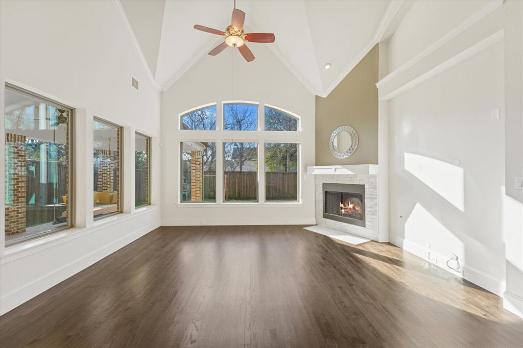 4026 North Cresthaven Road Dallas, TX 75209 - Photo 7 of 22 a view of an empty room with wooden floor fireplace and a window
