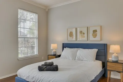 a bedroom with a bed and a window