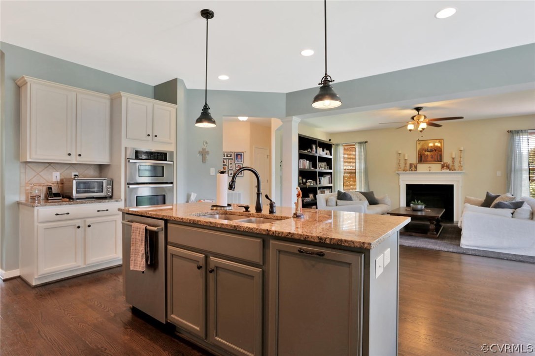 8910 Beaver Bridge Road Moseley, VA 23120 - Photo 12 of 44 a kitchen with kitchen island granite countertop a stove a sink a center island and wooden floor