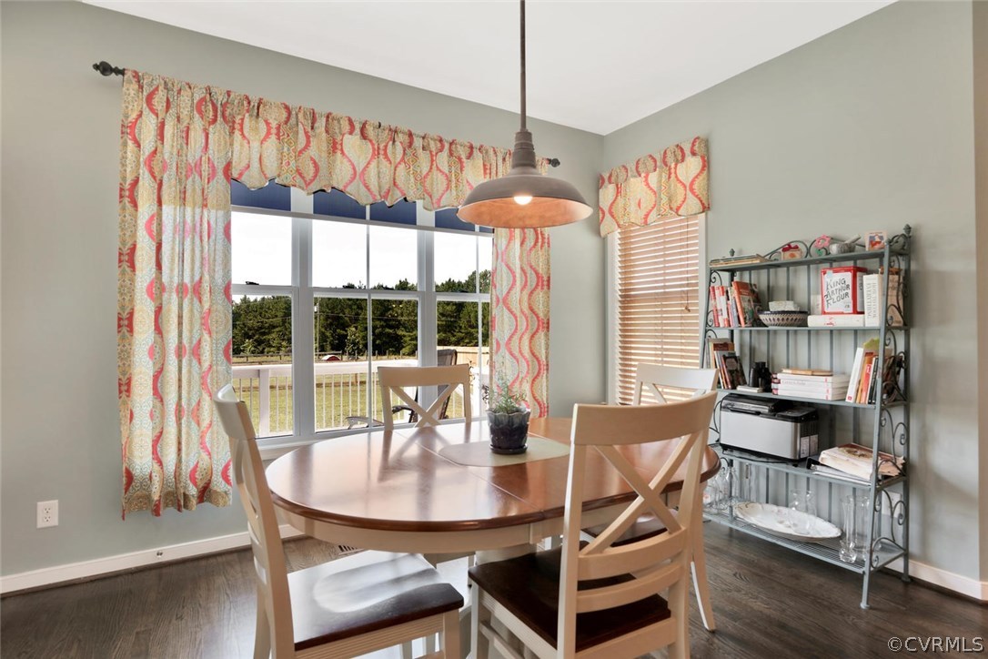 8910 Beaver Bridge Road Moseley, VA 23120 - Photo 13 of 44 a dining room with furniture a chandelier and wooden floor