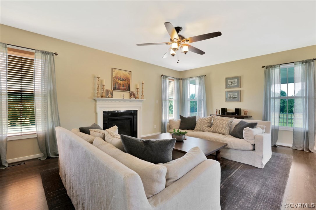 8910 Beaver Bridge Road Moseley, VA 23120 - Photo 17 of 44 a living room with furniture a fireplace and a large window