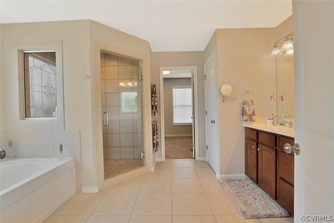 8910 Beaver Bridge Road Moseley, VA 23120 - Photo 23 of 44 a bathroom with a mirror a bathtub and shower
