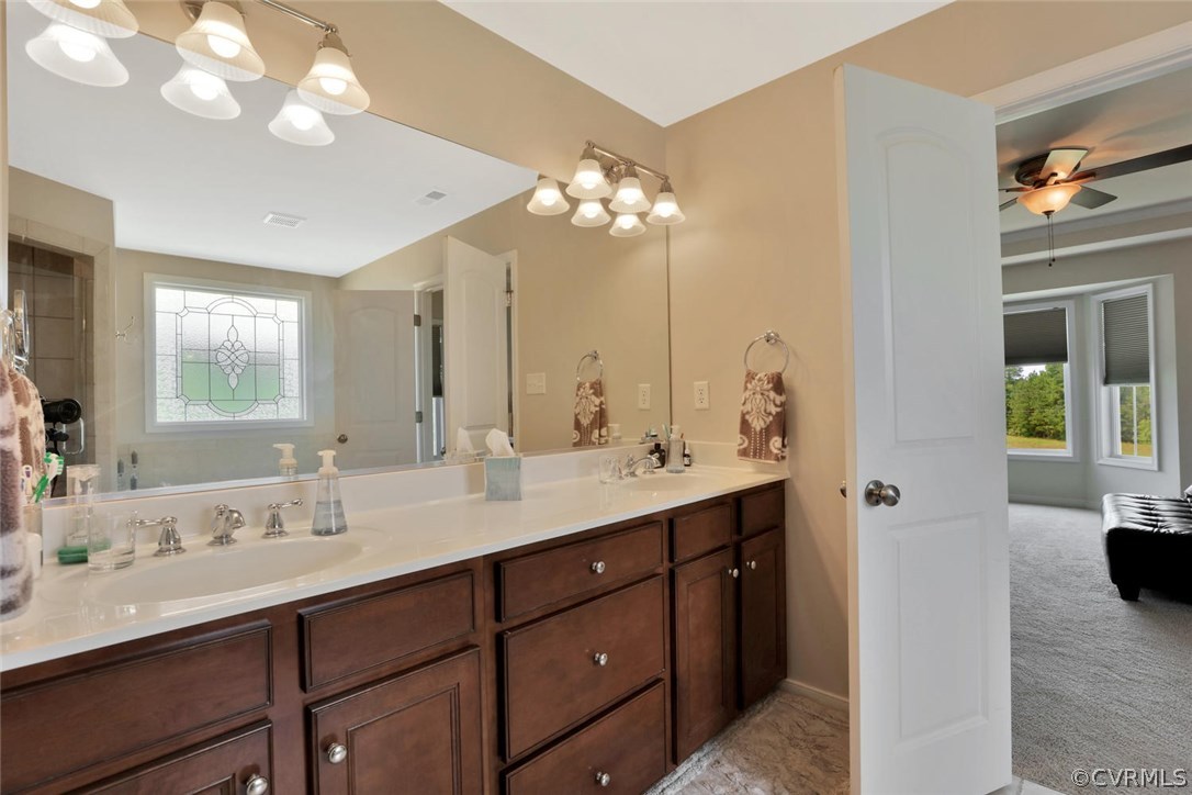 8910 Beaver Bridge Road Moseley, VA 23120 - Photo 25 of 44 a bathroom with a double vanity sink and a mirror
