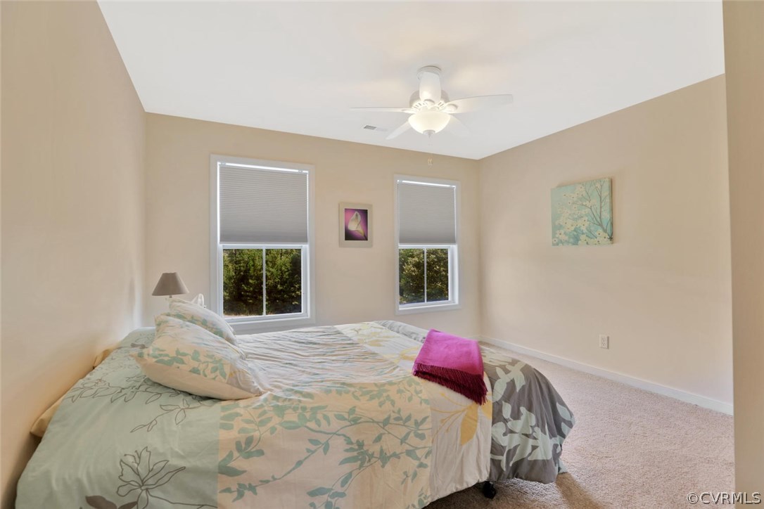 8910 Beaver Bridge Road Moseley, VA 23120 - Photo 26 of 44 a bedroom with a bed and a chandelier