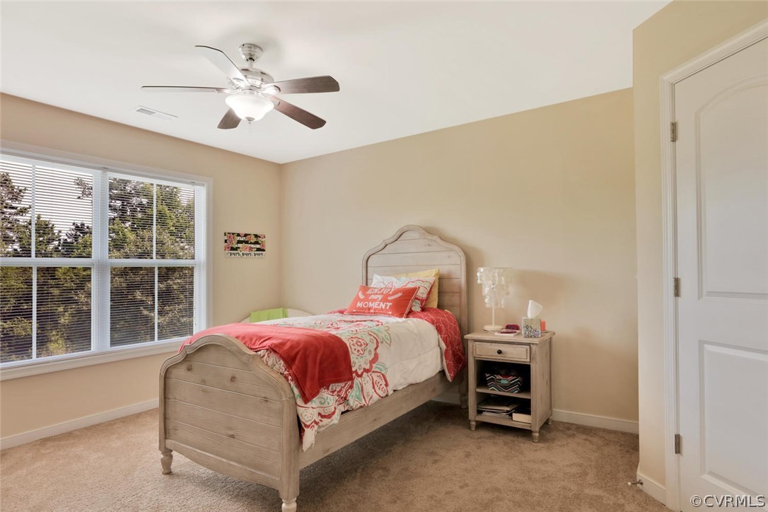 8910 Beaver Bridge Road Moseley, VA 23120 - Photo 28 of 44 a bedroom with a bed and a chandelier