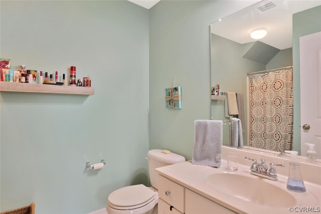 8910 Beaver Bridge Road Moseley, VA 23120 - Photo 29 of 44 a bathroom with a sink vanity mirror and toilet