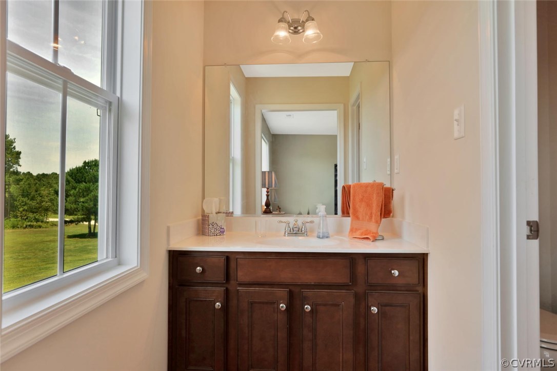 8910 Beaver Bridge Road Moseley, VA 23120 - Photo 31 of 44 a bathroom with a sink vanity and a mirror