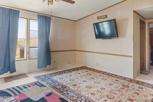 a view of a livingroom with wooden floor and a flat screen tv