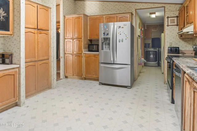 a kitchen with stainless steel appliances a refrigerator and a stove