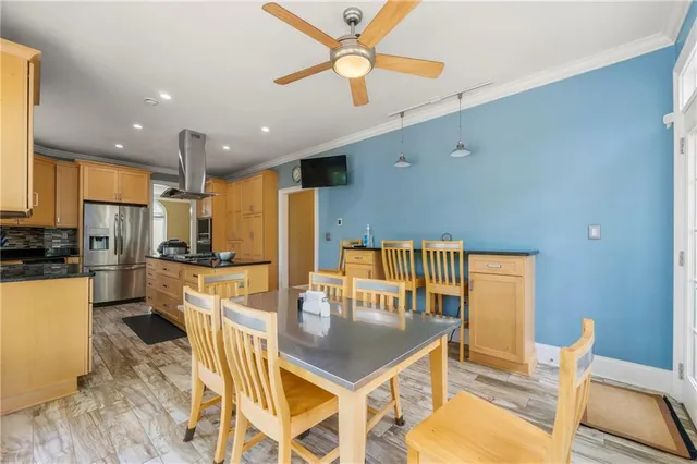 a kitchen with counter space dining table and stainless steel appliances