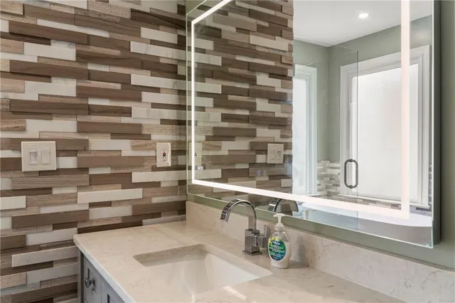 a kitchen with a sink and a large mirror