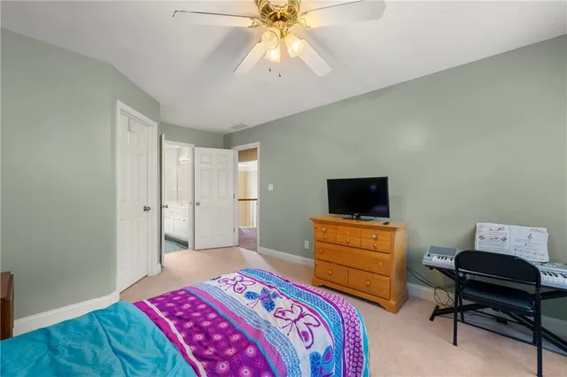 a bedroom with a bed and a television