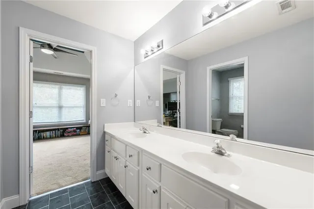 a bathroom with a double vanity sink and mirror