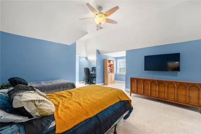 a bedroom with a bed and flat screen tv