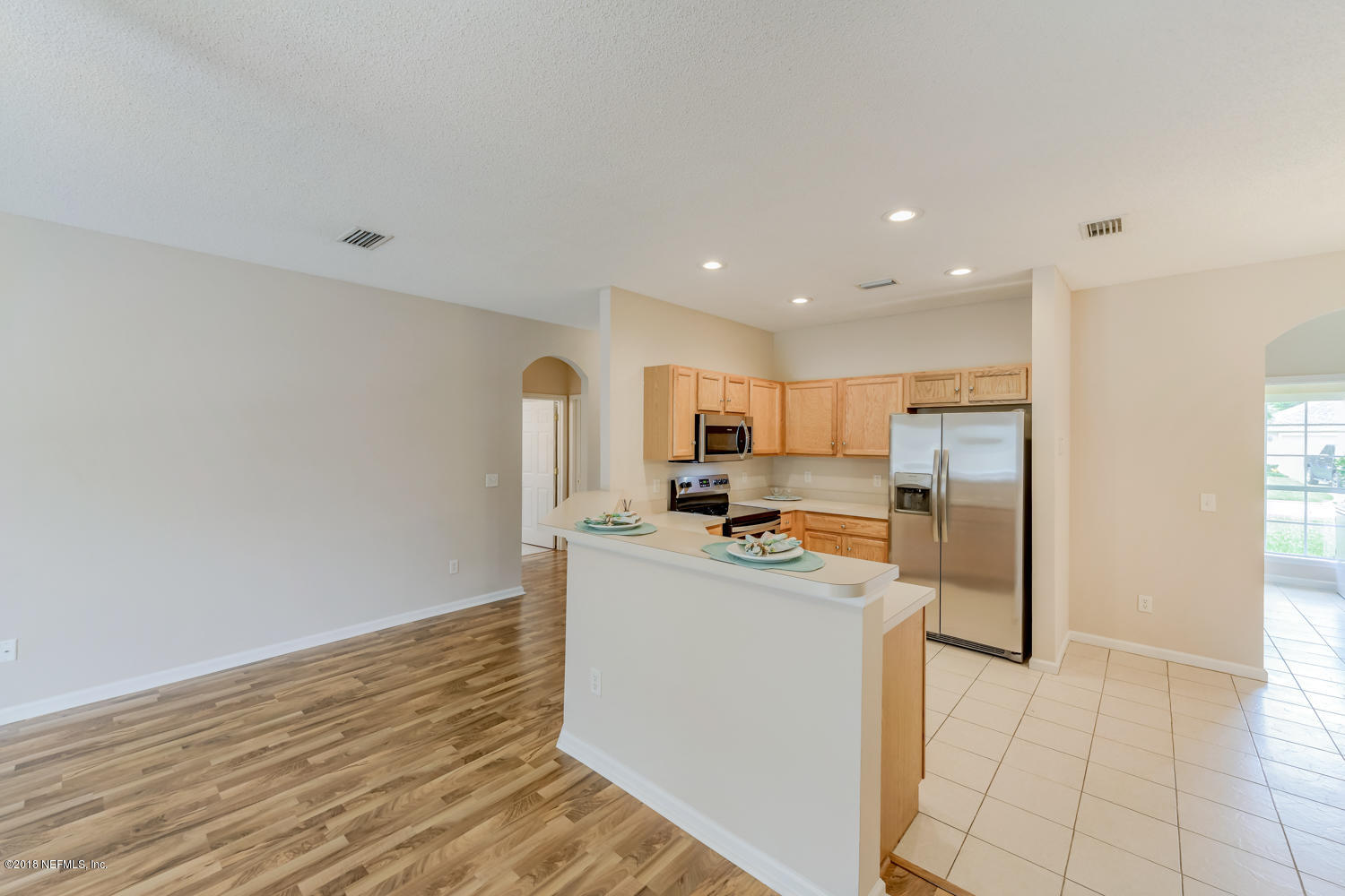 217 Merida Road St. Augustine, FL 32086 - Photo 7 of 37 a kitchen with stainless steel appliances a refrigerator and a stove top oven