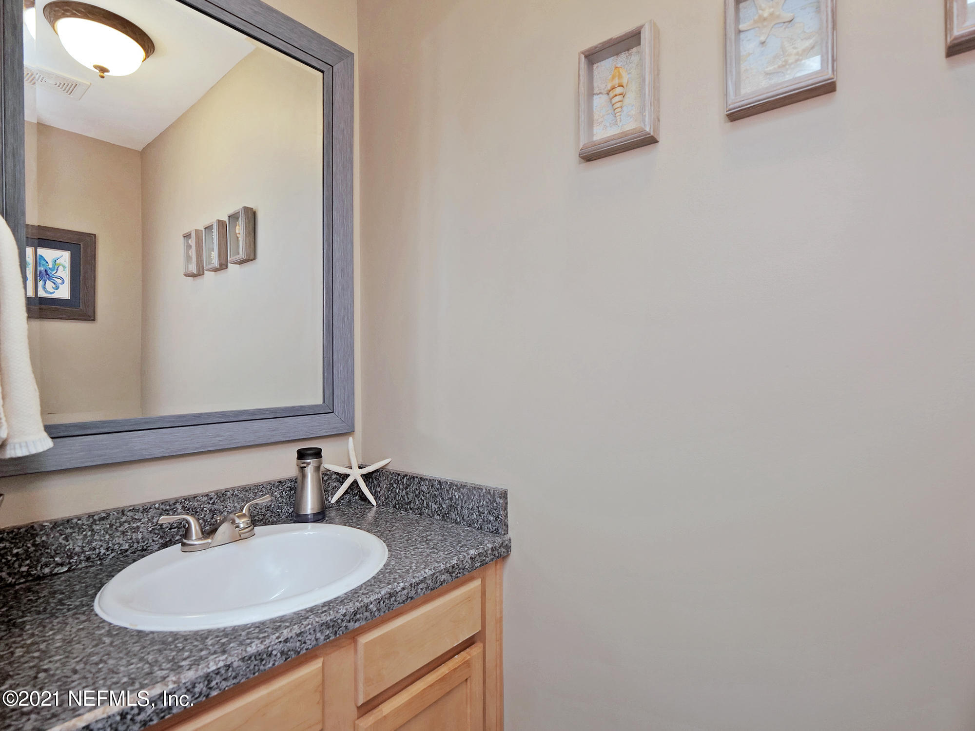 832 Cavalla Road Atlantic Beach, FL 32233 - Photo 14 of 34 a bathroom with a granite countertop sink and a mirror