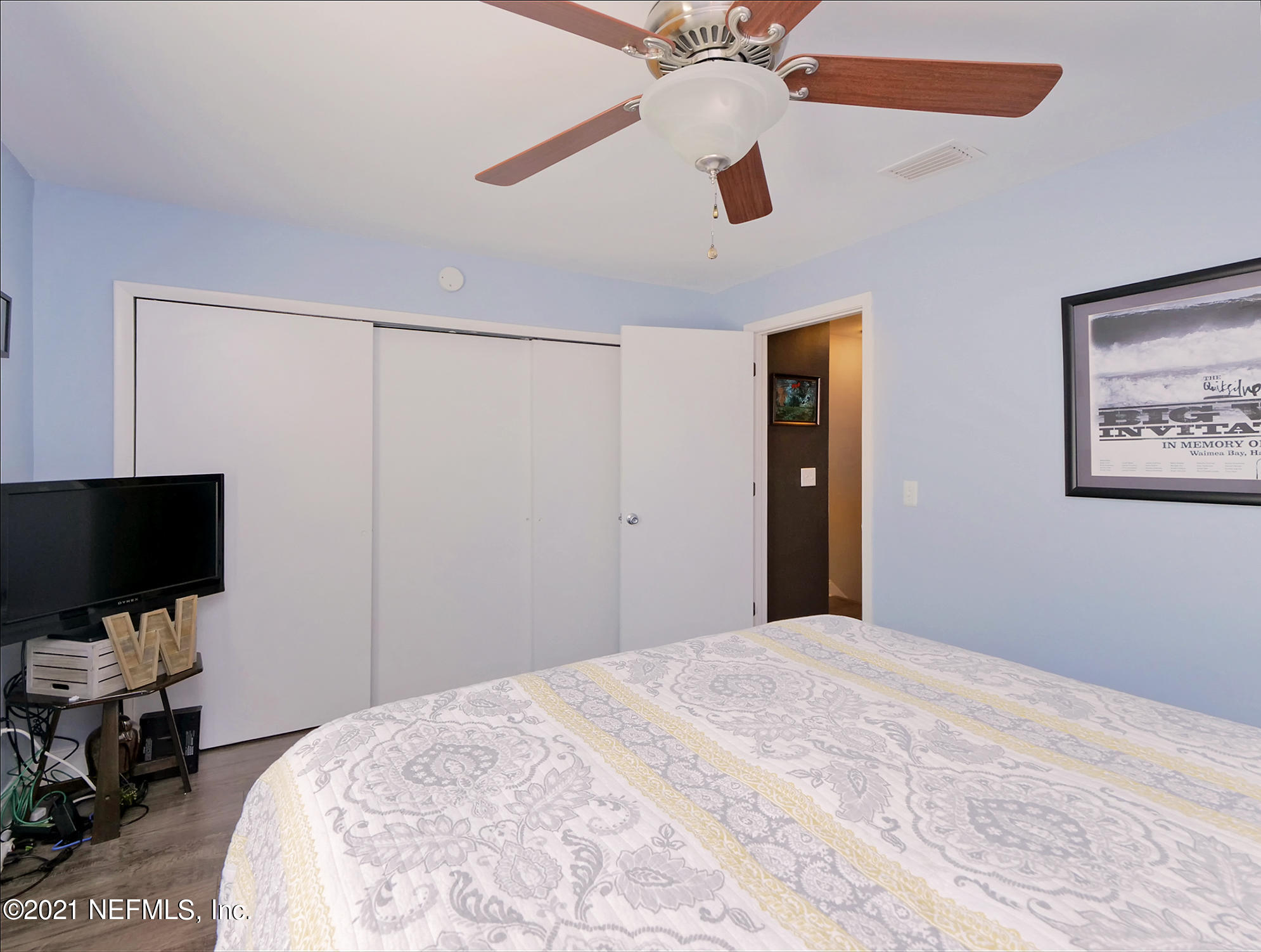 832 Cavalla Road Atlantic Beach, FL 32233 - Photo 17 of 34 a bedroom with a large bed and a flat tv screen