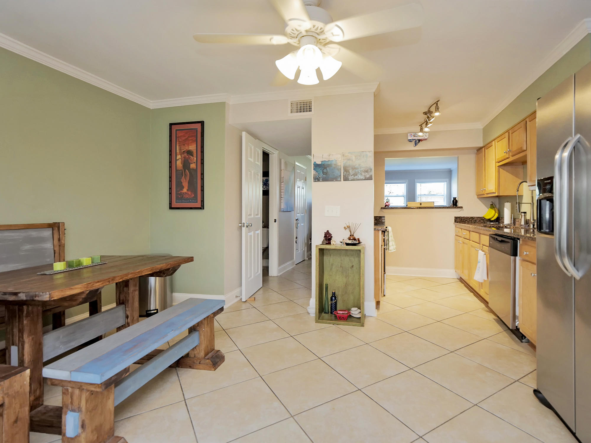 832 Cavalla Road Atlantic Beach, FL 32233 - Photo 7 of 34 a kitchen with stainless steel appliances kitchen island granite countertop a refrigerator and a stove top oven