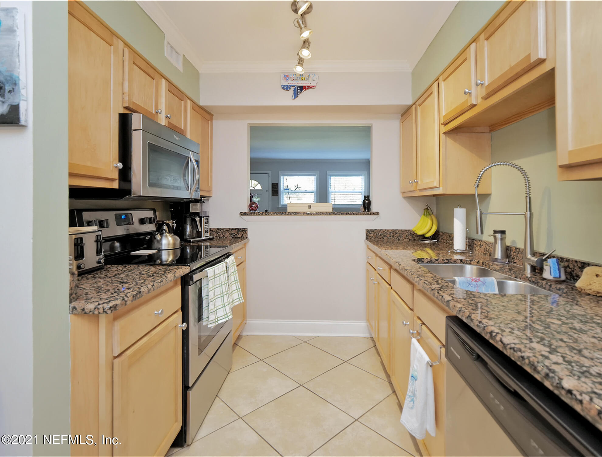 832 Cavalla Road Atlantic Beach, FL 32233 - Photo 9 of 34 a kitchen with stainless steel appliances granite countertop a sink stove and cabinets