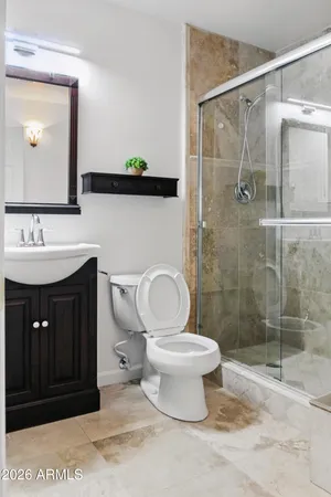 a bathroom with a sink toilet and shower